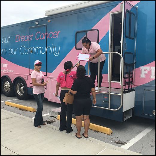 Women waiting to receive a mammogram on a mobile testing van