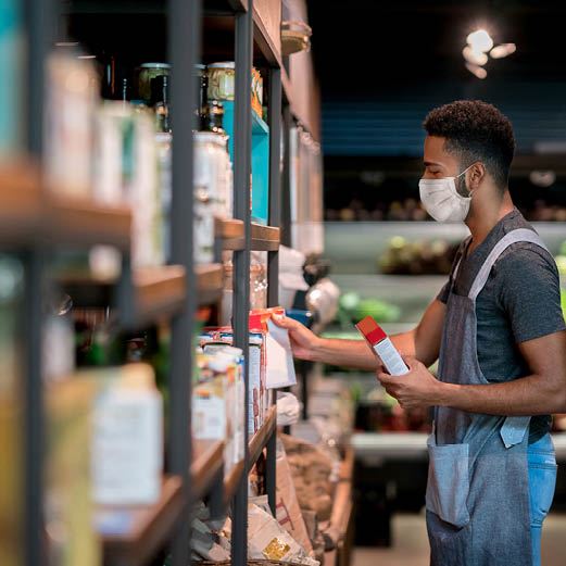 Small Business Owner Stocks Shelves