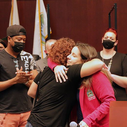 Councilwoman Avila hugs woman receiving award