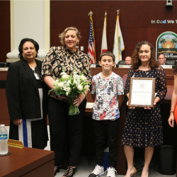 Bailey with Monica receiving award
